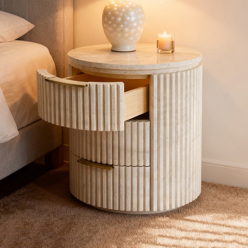 Fluted travertine nightstand with marble top - styled in modern bedroom with lamp and candle