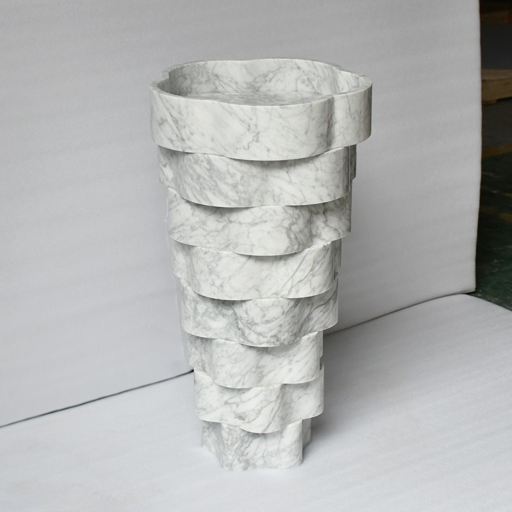 Close-up of Carrara marble sink basin - scalloped flower edge and natural veining detail