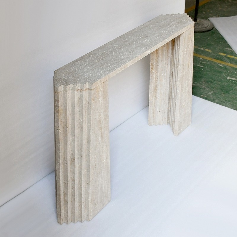 Close-up of travertine console table - fluted stepped leg detail and natural stone texture