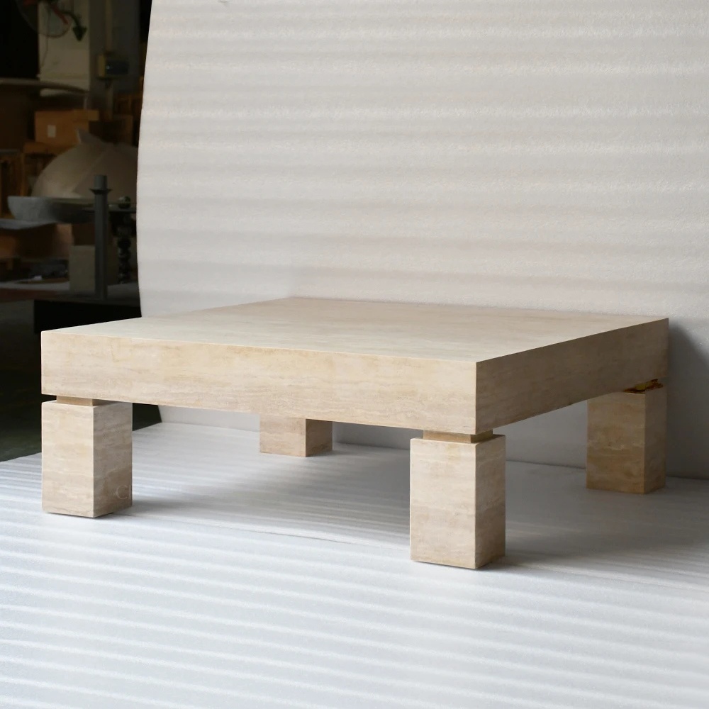 Close‑up of travertine coffee table - natural layered stone texture and block leg joint detail
