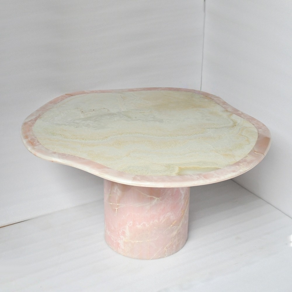 Luxury pink onyx statement table with irregular wavy edge and single column base